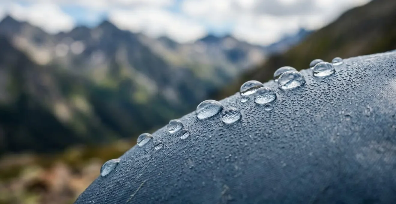 Close-up of water hydration system on mountain trail emphasizing moisture management at altitude