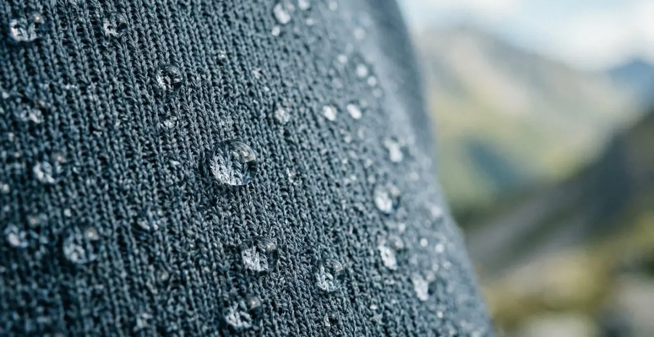 Close-up of synthetic moisture-wicking fabric fibers showing water repellency and thermal regulation technology