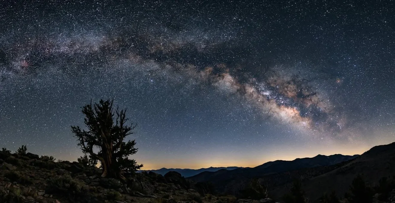 Pristine dark sky showing the Milky Way galactic core rising over remote wilderness landscape for astrophotography
