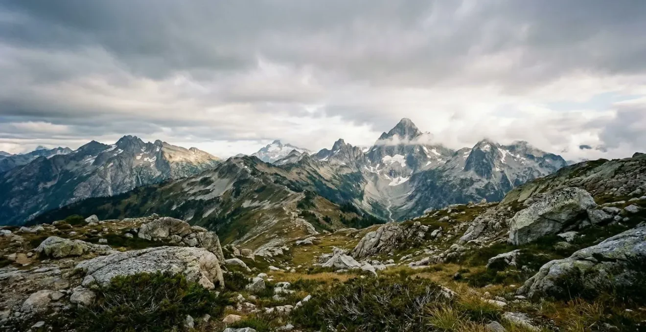 Wide-angle view of rugged mountain wilderness terrain showing strategic route planning elements