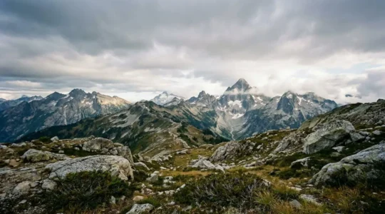 Wide-angle view of rugged mountain wilderness terrain showing strategic route planning elements